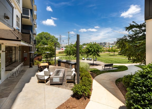 a patio with a fountain and seating area at the enclave at woodbridge apartments in sugar land  at Abberly Noda Vista Apartment Homes, North Carolina, 28206
