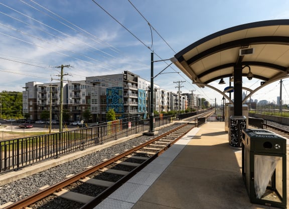 a train station with buildings in the background  at Abberly Noda Vista Apartment Homes, North Carolina, 28206