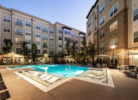 an apartment complex with a swimming pool  at Abberly Onyx Apartment Homes, Georgia, 30033