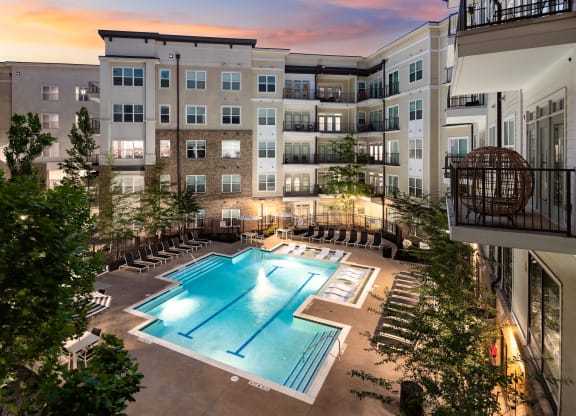 an apartment complex with a swimming pool  at Abberly Onyx Apartment Homes, Georgia
