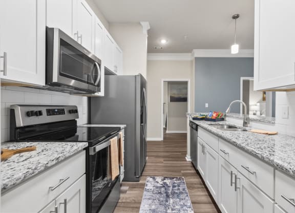 a kitchen with white cabinets and black appliances at West Ashley Apartment Homes, Charleston, South Carolina 29414
