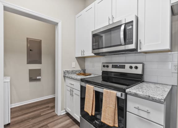 a kitchen with white cabinets at West Ashley Apartment Homes, South Carolina 29414