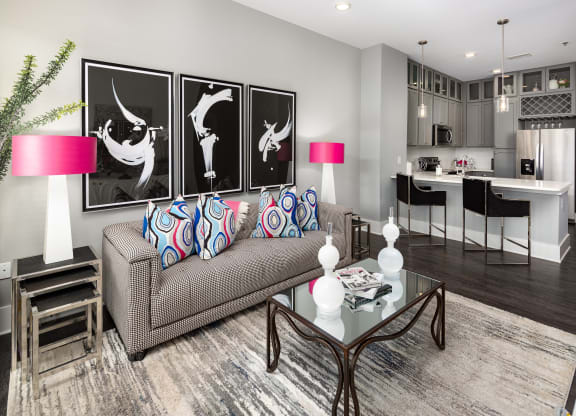 a living room with a couch and a glass table  at Abberly Onyx Apartment Homes, Decatur, Georgia
