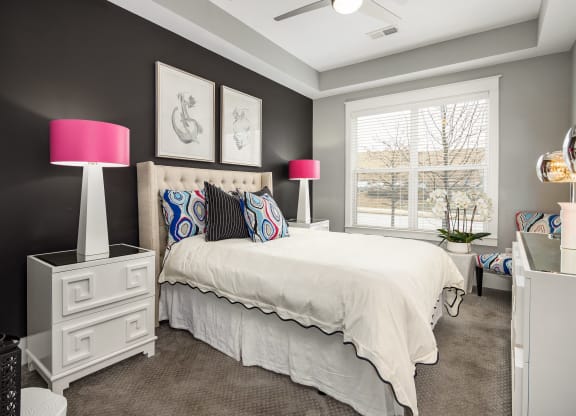 a bedroom with a large bed and a window  at Abberly Onyx Apartment Homes, Decatur, Georgia