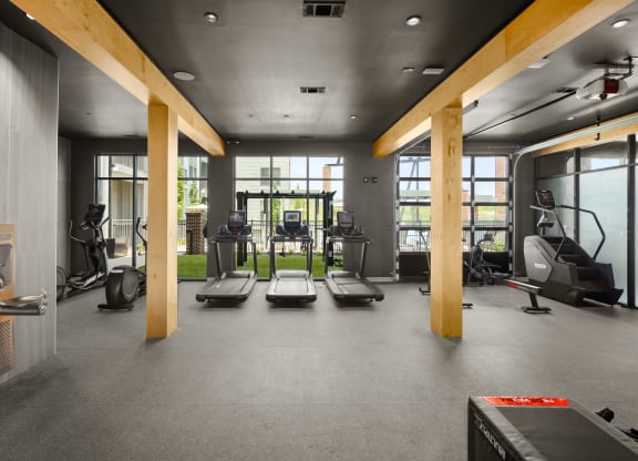 a spacious fitness room with cardio machines and weights at Abberly Riverwalk Apartment Homes, Nashville, TN, 37228