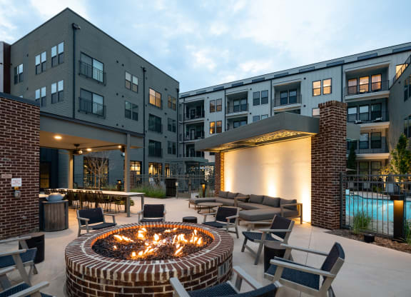 an outdoor patio with a fire pit and lounge chairs at Abberly Riverwalk Apartment Homes, Nashville, TN