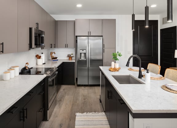 a kitchen with dark cabinets and white countertops  at Abberly Riverwalk Apartment Homes, Tennessee, 37228