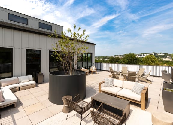 a patio with couches and chairs on a roof at Abberly Riverwalk Apartment Homes, Nashville, Tennessee