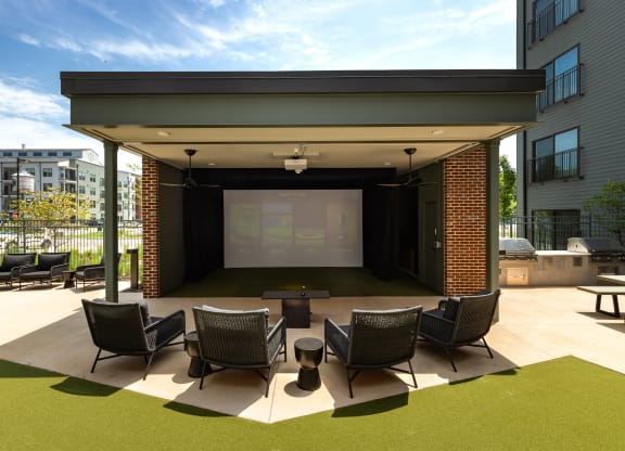 a large outdoor stage with chairs and a table in front of a large projection screen at Abberly Riverwalk Apartment Homes, Nashville, 37228