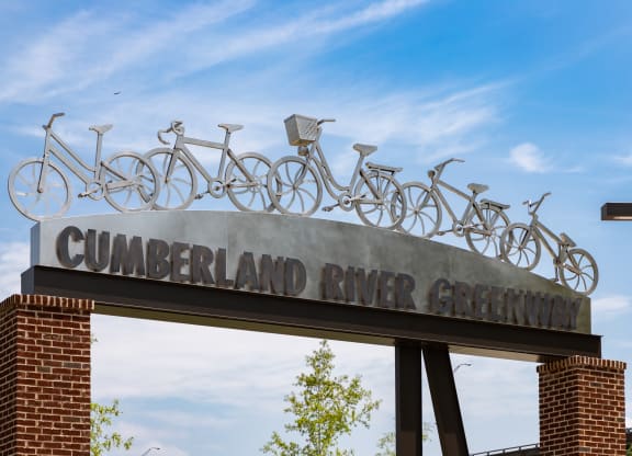 a sign for the cumberland river greenway with bikes on top of it at Abberly Riverwalk Apartment Homes, Nashville
