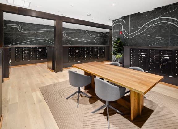 a conference room with a wooden table and grey chairs in front of a large blackboard with at Abberly Riverwalk Apartment Homes, Nashville