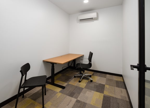 a small room with a table and two chairs