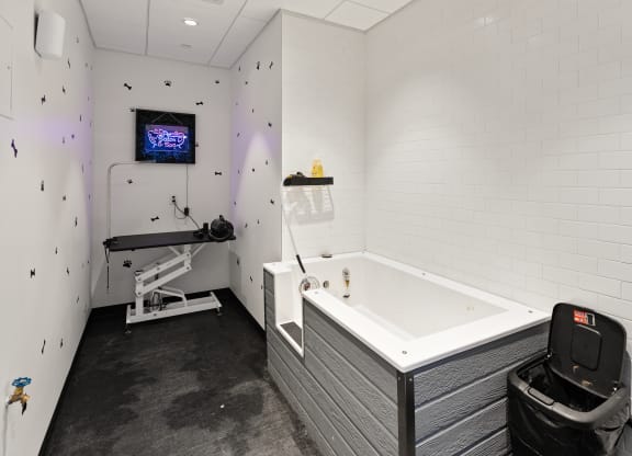 a bathroom with a bathtub and a tv on the wall at Abberly Riverwalk Apartment Homes, Tennessee, 37228