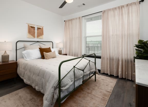 a bedroom with a bed and a window  at Abberly Riverwalk Apartment Homes, Nashville, 37228