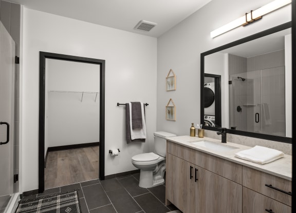 a bathroom with white walls and a black and white tiled floor  at Abberly Riverwalk Apartment Homes, Nashville, TN, 37228