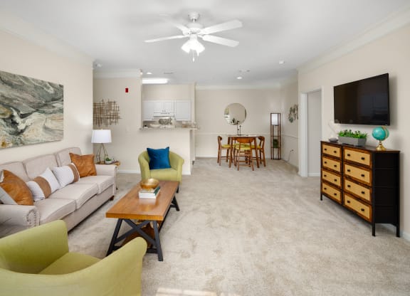 a living room with beige carpet and a ceiling fan at Abberly Grove Apartment Homes, North Carolina, 27610