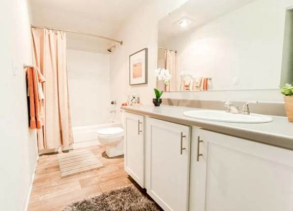 A bathroom with a toilet, sink, and shower at Altitude Apartment , Tacoma