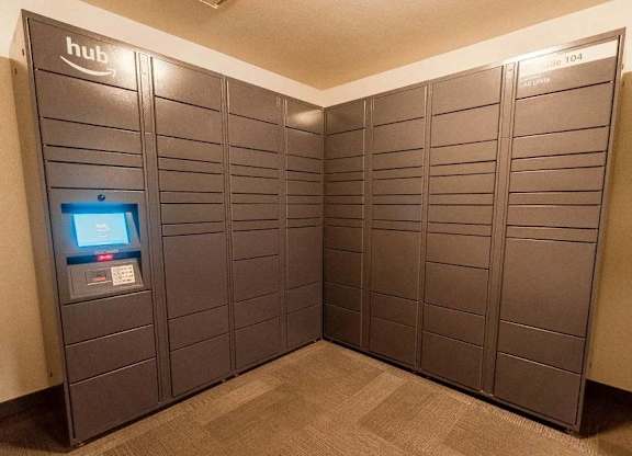 A row of lockers with a computer screen on the left at Altitude Apartment , Tacoma, Washington