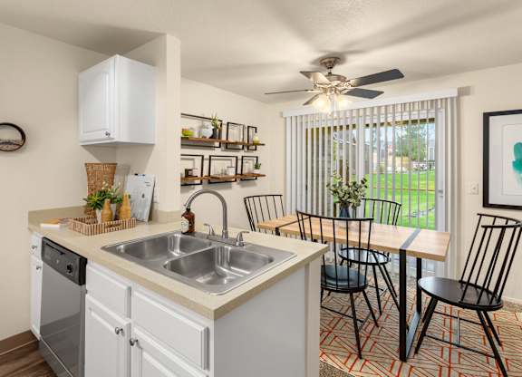 A kitchen with a white dishwasher and a white sink.