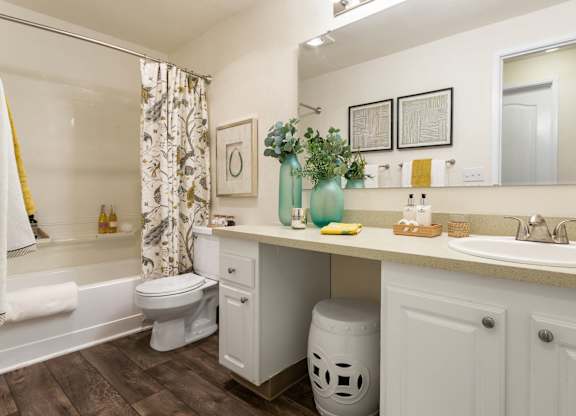 A white bathroom with a white toilet and a white sink.