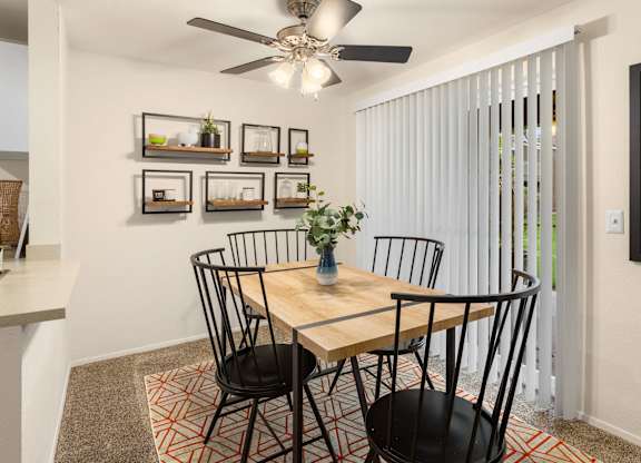 A dining room with a table and chairs.