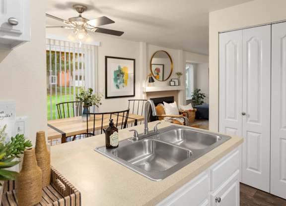 A kitchen with a sink and a fan.