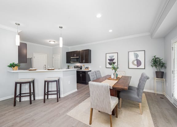 a dining room and kitchen with a table and chairs