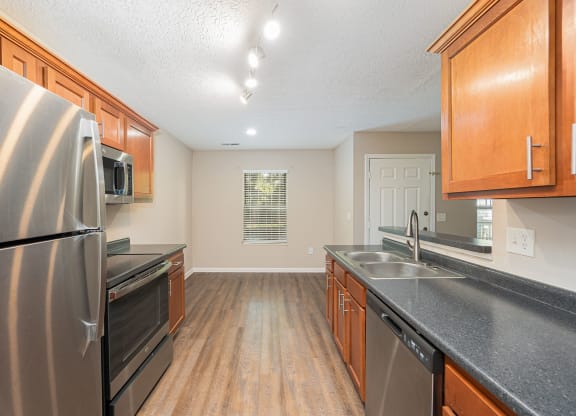 a kitchen with stainless steel appliances and wooden cabinets