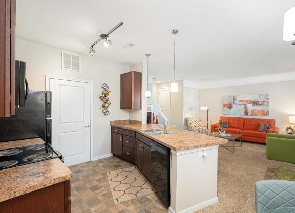 an open kitchen and living room with a counter top