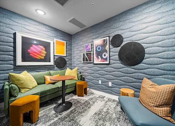 A living room with a blue couch and a green couch.