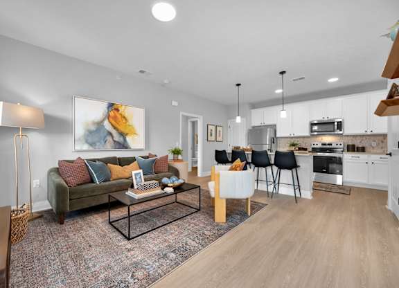 A modern living room with a couch, chairs, and a coffee table.