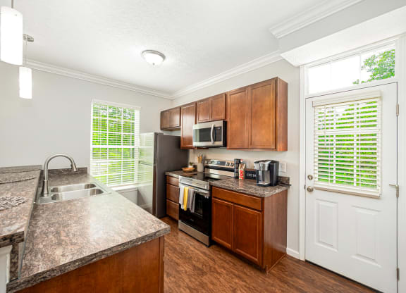 a kitchen with stainless steel appliances and wooden cabinets