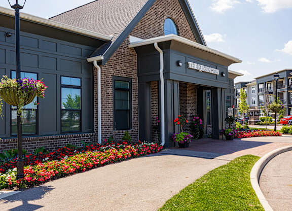 The entrance to a building with a sign that reads "The Residences".