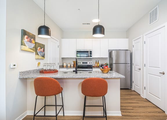 a kitchen with a granite counter top and two stools