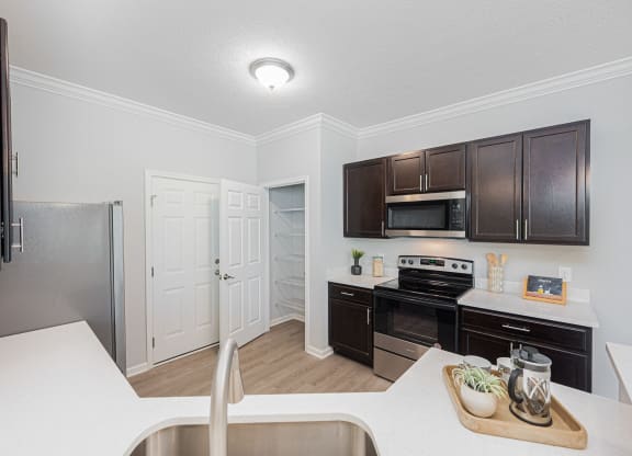 a kitchen with black appliances and brown cabinets
