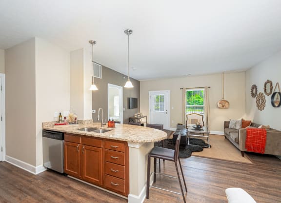a kitchen with an island and a living room with a couch