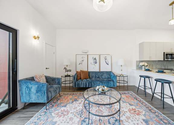 A living room with a blue couch and a coffee table.