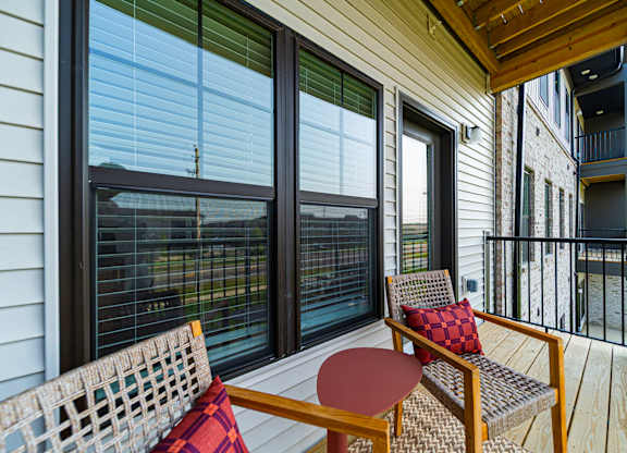 A wooden table and chair set on a balcony.