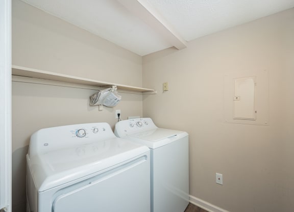 a white washer and dryer in a laundry room with a white door