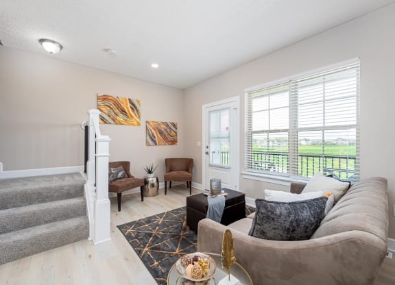 a living room with a staircase and a couch