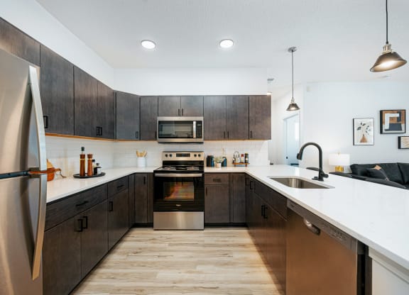 a large kitchen with wooden cabinets and stainless steel appliances