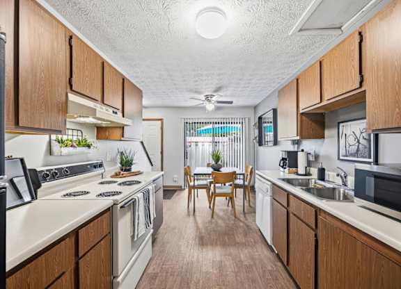 A kitchen with wooden cabinets and a white countertop.