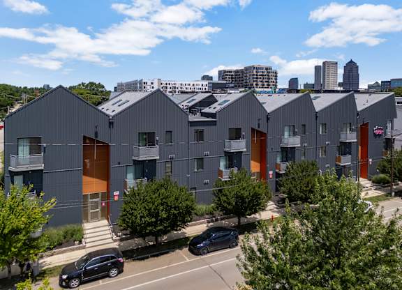 A modern building complex with grey and orange exterior.