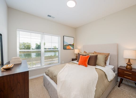 a bedroom with a large bed and a window
