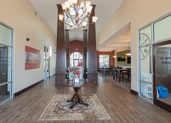 a large lobby with a table and a chandelier