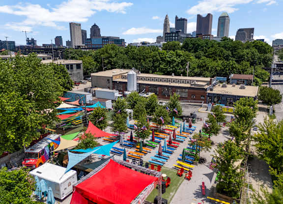 A city park with a lot of trees and a lot of tents.