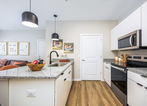 a kitchen with granite counter tops and stainless steel appliances