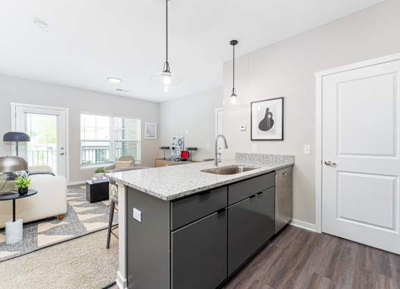 A kitchen with a sink and a counter.