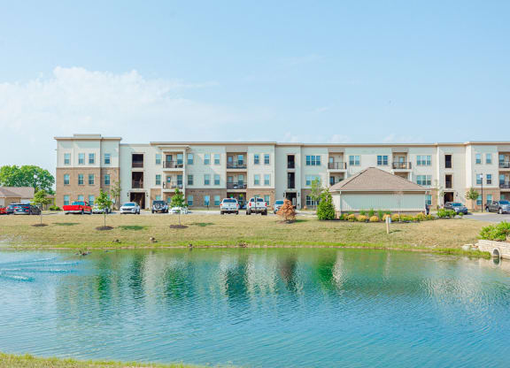 an image of an apartment building overlooking a lake