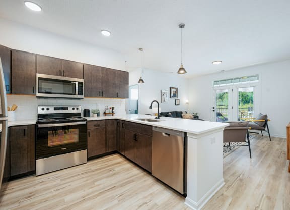 a large kitchen with wooden cabinets and stainless steel appliances